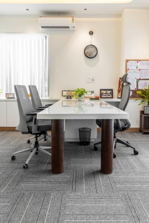 A professional office interior featuring a conference table, chairs, and decor in Sahibzada Ajit Singh Nagar.